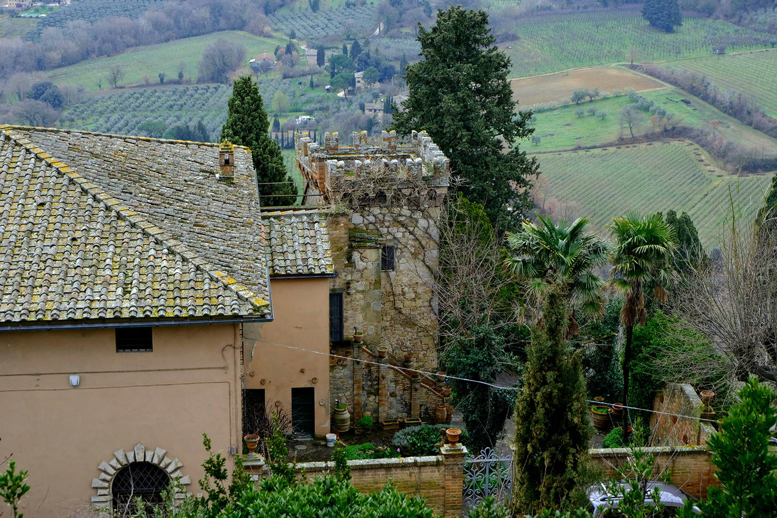 Historic stone tower and rural buildings in the Tuscan landscape