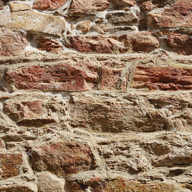 Warm light revealing the texture of a Tuscan stone and brick wall
